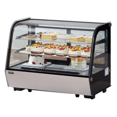 Curved glass refrigerated bakery display case with 2 tiers of cakes and pastries.