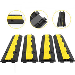 Four black and yellow rubber cable protector ramps with two channels each, shown in a pack of four.