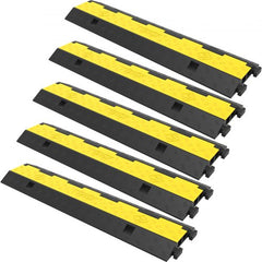 Five black and yellow rubber cable protector ramps are arranged diagonally.