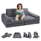 A young child sits on a grey modular kids play couch reading a book, with inset views of foam pieces and configurations.