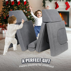 Two young children play with a 10-piece grey modular kids play couch in a cozy living room with Christmas decorations.