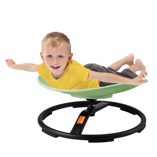 A young boy lies and spins happily on a green Bostome Kids Sensory Swivel Chair with a black metal base.