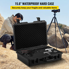 Black 15.6-inch waterproof hard case with foam interior, open on desert ground near camera gear.