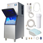 Stainless steel commercial ice maker with open lid, blue-lit ice compartment full of cubes, and accessories including water filter and scoop.