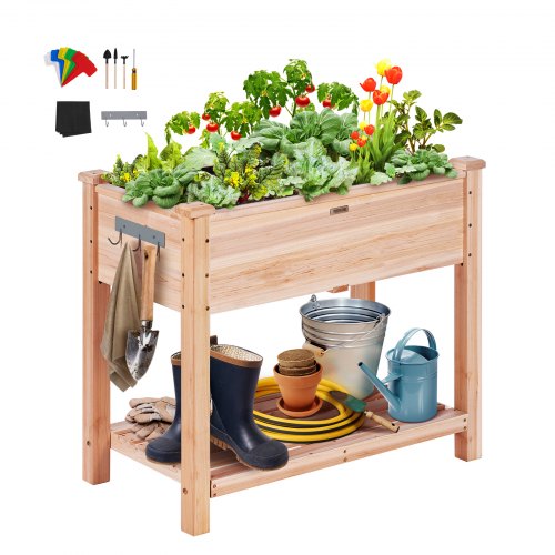 Elevated fir wood raised garden bed planter box with plants, tools, and storage.
