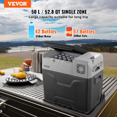 Gray and black 50L single-zone portable compressor car refrigerator freezer, open with bottles inside, on a picnic table outdoors.