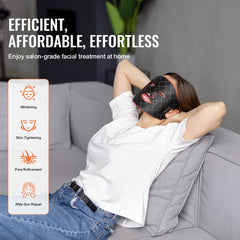 Woman wearing Bostome LED face mask with red light therapy on a couch.