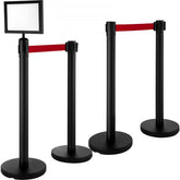 Black stainless steel stanchions with retractable belts and sign frame for crowd control.