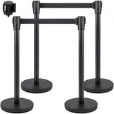 Four black belt stanchions with round bases for crowd control and flexible barrier setup.