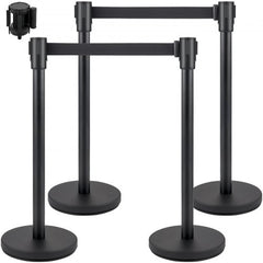 Four black belt stanchions with round bases for crowd control and flexible barrier setup.