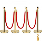 Four gold stanchion posts with red velvet ropes and snap ends.