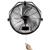 A black 18-inch VEVOR wall-mount fan with metal blades and pull chain, shown mounted and with a hand pulling the chain.