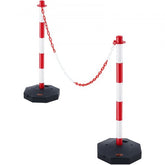 Two red and white adjustable traffic delineator posts with chain, on black bases.