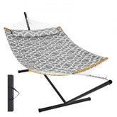 Gray quilted two-person hammock with black steel stand and wooden spreader bars.