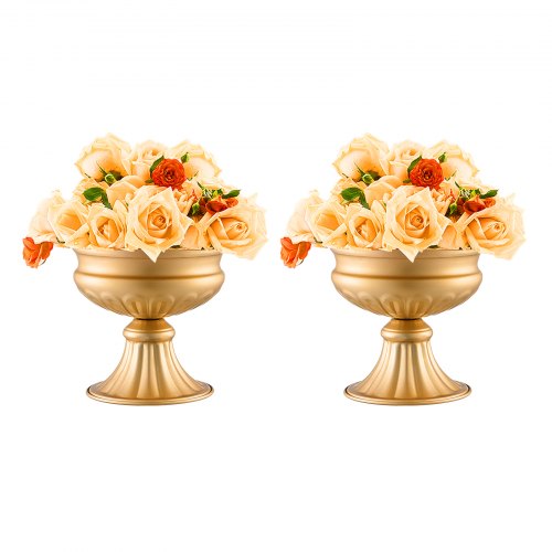 Pair of gold pedestal vases filled with orange roses and greenery.