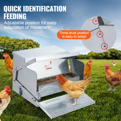 Silver galvanized steel automatic chicken feeder with adjustable treadle and 25 lb capacity, shown with chickens eating outdoors.