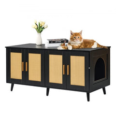 Black wooden cat litter box enclosure cabinet with rattan doors, cat entry hole, and orange cat lounging on top.