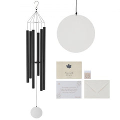 A black wind chime with six tubes, a circular wind catcher, and two gift cards.
