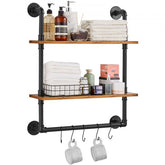 Two-tier industrial pipe shelf with black metal pipes, wooden shelves, towels, and bathroom items.