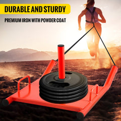 Red power speed training sled with weight plates and harness on sandy terrain.