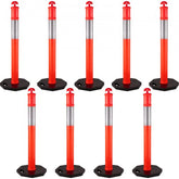 Nine orange 44-inch traffic delineator posts with reflective bands and weighted rubber bases.