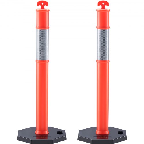 Two orange reflective traffic delineator posts with rubber bases and red arrow tops.