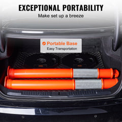 Two orange traffic delineator posts with wide rubber bases and reflective strips in a car trunk.