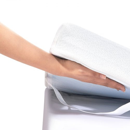 Hand lifting soft white memory foam mattress topper with washable cover on bed.