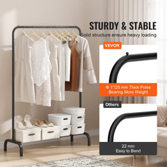 Heavy-duty black metal clothing rack with hanging rod, bottom shelf, and storage bins holding clothes and shoes.