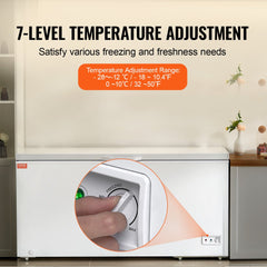 White Bostome chest freezer with 7-level temperature dial from -28°C to 10°C and hand adjusting it.