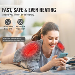 Woman using a 12x24in weighted heating pad on her shoulders while relaxing on a bed.