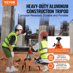 Two men using an adjustable aluminum laser level tripod stand at a construction site.