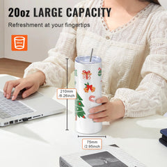 Woman holding a 20oz stainless steel tumbler with Christmas designs, lid, and straw on a desk.