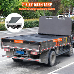 Black 7x22 ft mesh tarp covering a dump truck bed with side flaps and grommets.