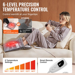Person using Bostome electric heated foot warmer with remote control on a couch.