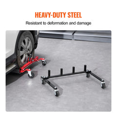 Black steel car dolly rack with four slots and swivel casters on a garage floor.