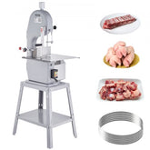 A gray meat bandsaw with a stand, accompanied by various cuts of meat and extra blades.
