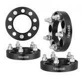 Set of four black 1-inch 5x4.5 inch 5-lug forged aluminum wheel spacers with bolts.