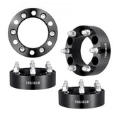 Four black forged aluminum 2-inch wheel spacers with 6x5.5-inch 6-lug pattern.
