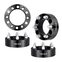Set of four black 2-inch forged aluminum wheel spacers with 6x5.5 inch bolt pattern.