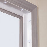 White TPE seal strip for garage door top and sides, shown installed in a gray frame.