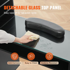 Black manicure table with a glass top, storage cabinets, and ergonomic wrist rest.