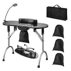 A black foldable manicure table with a dust collector, lamp, and carrying bags.