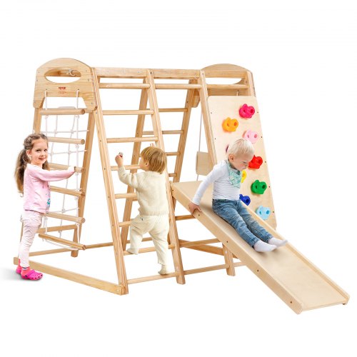 Wooden indoor jungle gym with ladders, climbing wall, slide, and toddlers playing.