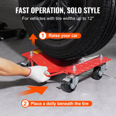 Red heavy-duty wheel dolly positioned under a car tire, with hand guiding it into place.