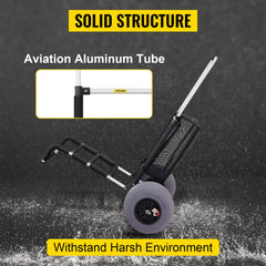 Black folding beach cart with large wheels and mesh storage bag on textured surface.