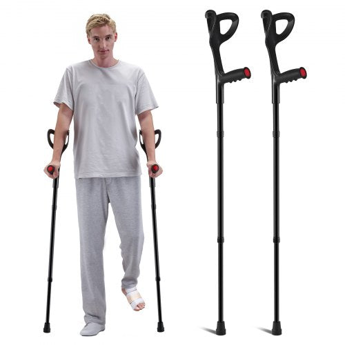 A man uses black forearm crutches with red accents, while two identical crutches stand beside him.