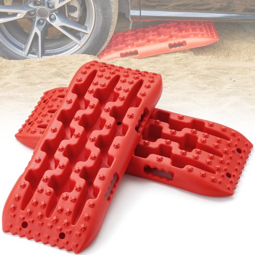 Two red traction boards made of durable PP material for off-road recovery in mud and snow.