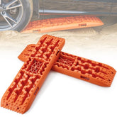 Two orange PP traction boards with cross-tooth patterns for off-road vehicle recovery.
