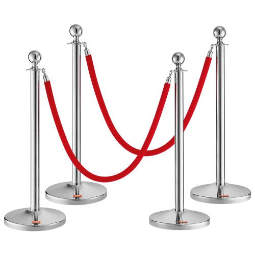 Four stainless steel stanchion posts with red velvet ropes for crowd control and event management.